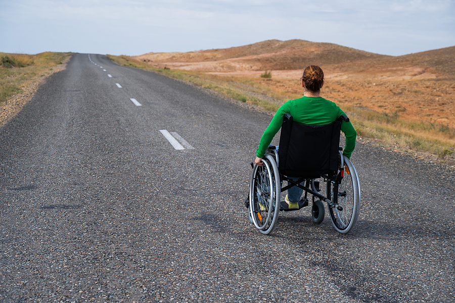 Woman in a wheelchair on a highway. Dr. Ethan Bregman offers supportive, targeted therapy to help athletes navigate the emotional aftermath of injury, including grief, anxiety, frustration, and fear of re-injury.